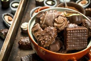 Chocolate candies in bowl. . photo