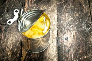 open tin can with pickled pineapple. photo