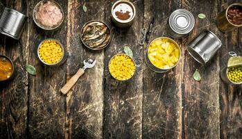 Various canned vegetables, meat, fish and fruits in tin cans. photo