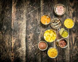 Various canned vegetables, meat, fish and fruits in tin cans. photo