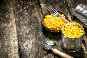 Canned corn in a tin can with opener. photo