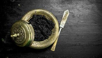 Black caviar in a bowl. photo