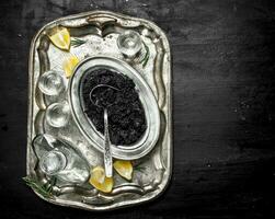 Vodka with caviar on the old tray. photo