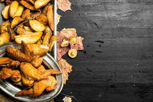 Smoked chicken wings with fried potatoes. photo