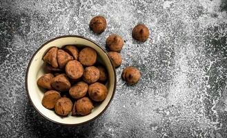 Chocolate truffles in a bowl. photo