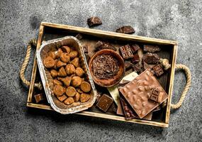 Different kinds of chocolate, truffles and chocolate chips. photo