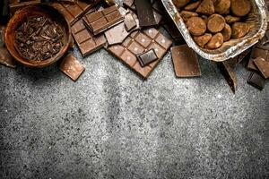 Different kinds of chocolate in bowls. photo