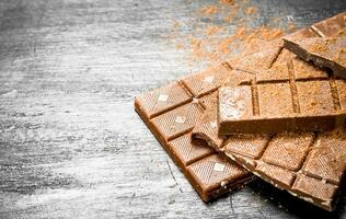 Chocolate bars with cocoa powder. photo