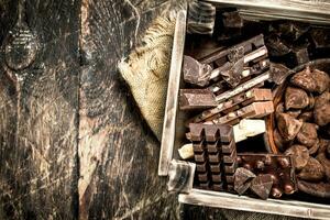 Different chocolate and sweets in an old box. photo