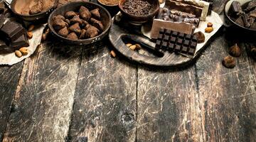 Chocolate bars with truffles and cocoa powder. photo