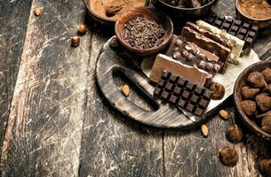 Chocolate bars with truffles and cocoa powder. photo