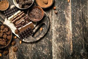 Chocolate bars with truffles and cocoa powder. photo