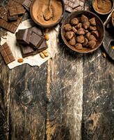 Chocolate bars with truffles and cocoa powder. photo