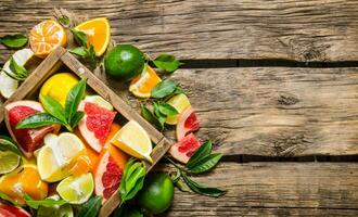 Citrus - grapefruit, orange, tangerine, lemon, lime in an old box. photo