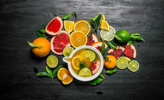 The juice of citruses - grapefruit, orange, tangerine, lemon, lime in a Cup. photo