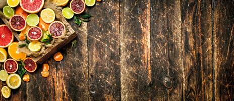 Citrus background. Citrus fruits in an old box. photo