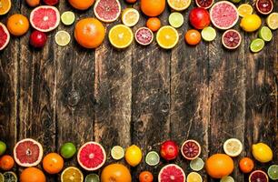 Citrus background. Fresh citrus fruits - Lemons, oranges, limes, grapefruits. photo