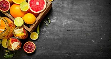 Citrus background. Fresh citrus juice with slices of limes, oranges, grapefruits and lemons. photo