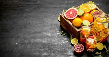 Citrus background. Fresh citrus juice with slices of limes, oranges, grapefruits and lemons. photo