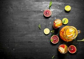 Citrus background. Fresh citrus juice with slices of limes, oranges, grapefruits and lemons. photo