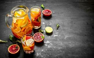 Citrus background. Fresh citrus juice with slices of limes, oranges, grapefruits and lemons. photo