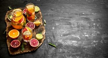 Citrus background. Fresh citrus juice with slices of limes, oranges, grapefruits and lemons. photo