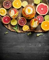 Citrus background. Fresh citrus juice with slices of limes, oranges, grapefruits and lemons. photo