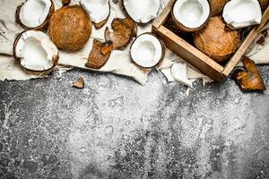 Fresh coconuts in an old box on the fabric. photo