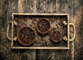 Coffee beans in bowls on a tray. photo