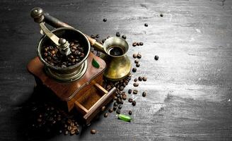 Welded coffee in a Turkish with a hand grinder. photo