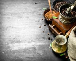 Coffee background. Fresh coffee in a Turkish with a hand grinder. photo