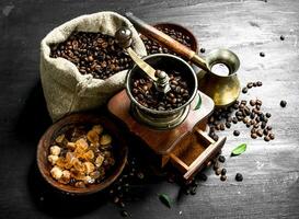 Welded coffee in a Turkish with a hand grinder. photo