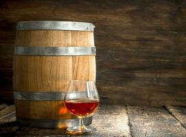 barrel with a glass of cognac. photo