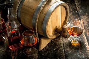 barrel with a long cognac and glasses. photo