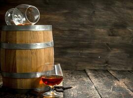 barrel with glasses of French cognac. photo