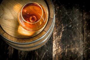 barrel with a glass of cognac. photo
