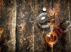 French cognac with a smoking cigar. photo