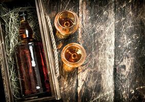 bottle of cognac in an old box. photo