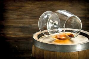 barrel with a glass of cognac. photo