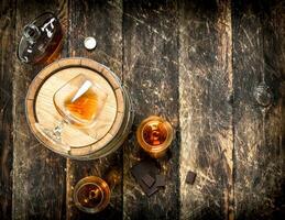 barrel with glasses of French cognac. photo