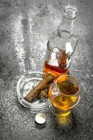 glass of cognac with a cigar. photo