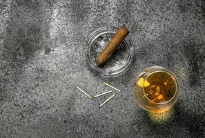 glass of cognac with a cigar. photo