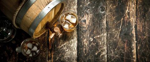 barrel of Scotch whiskey with a glass. photo