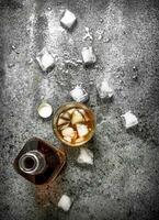 glass of whiskey with ice cubes. photo