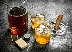 Scotch whiskey with a cigar. photo