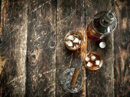 Whiskey with ice and a cigar. photo