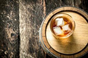 glass of Scotch whiskey with a barrel. photo