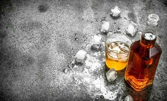 glass of whiskey with ice cubes. photo