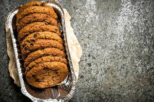 Oatmeal cookies in a bowl with nuts. photo