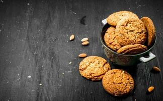 Oatmeal cookies in a bowl with almonds. photo